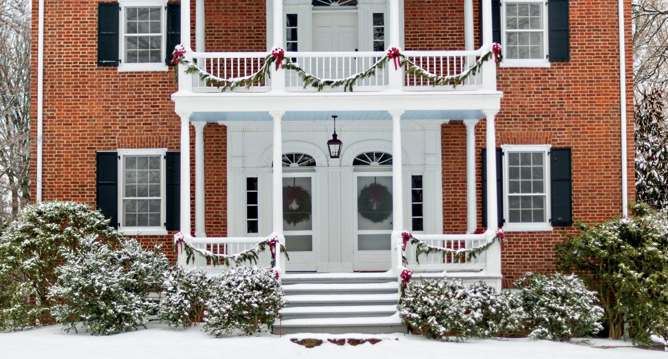 Main House decorated for holidays with snow