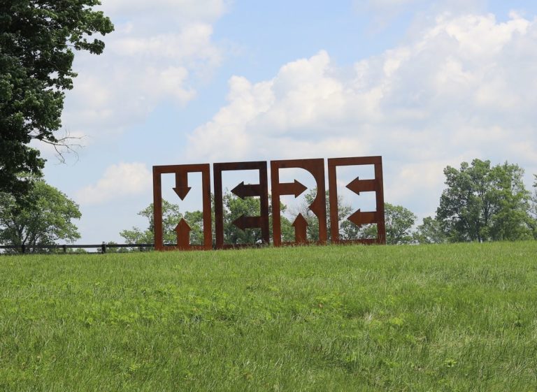 Large outdoor art installation of the letters H-E-R-E