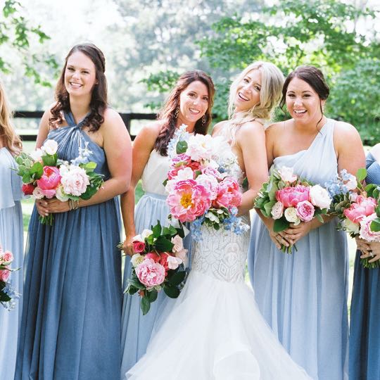 bridesmaids with flowers smiling and laughing